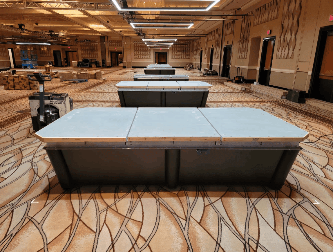 Ballroom full of tournament tables being assembled
