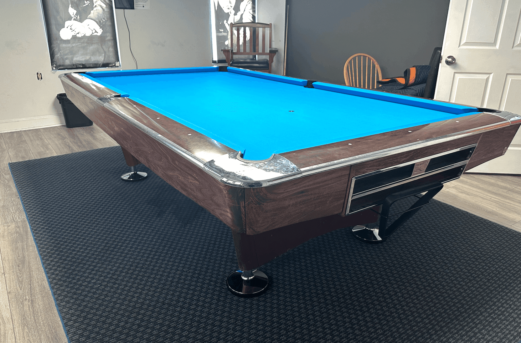 Brown table with blue cloth on a dark area rug