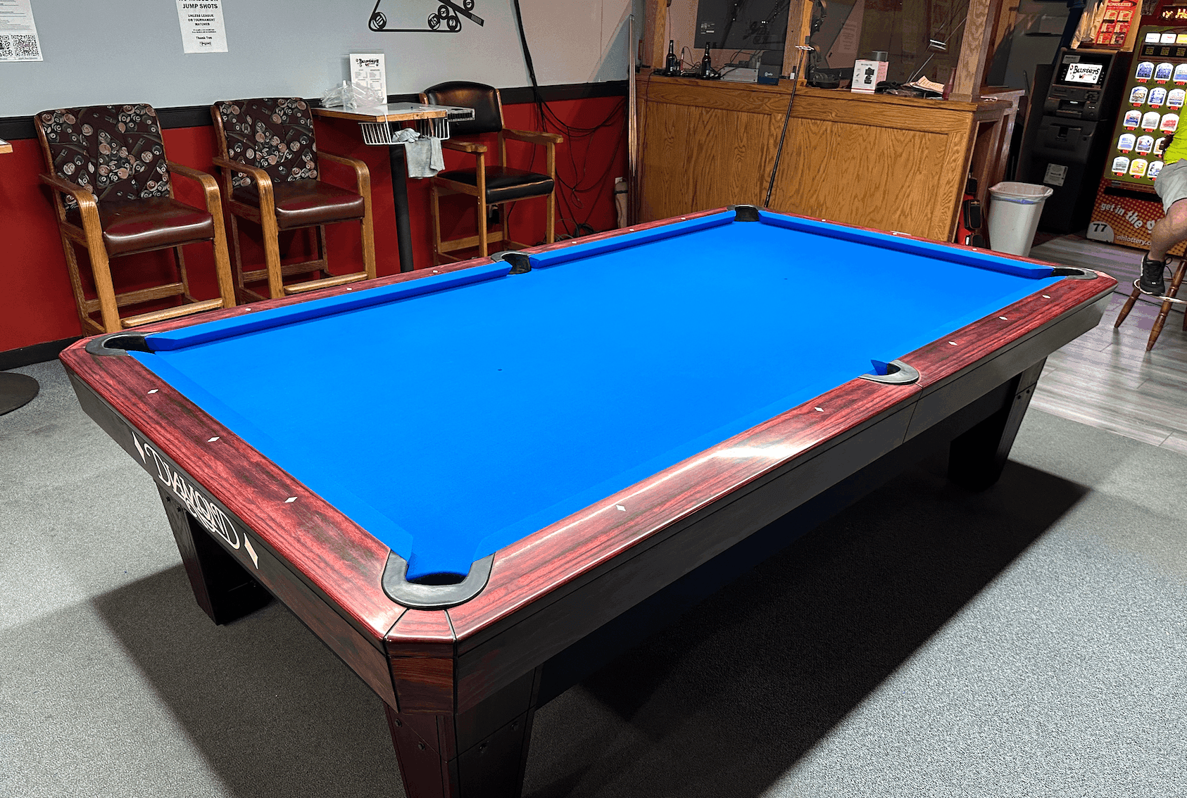 Diamond table with red rails and blue cloth in a bar