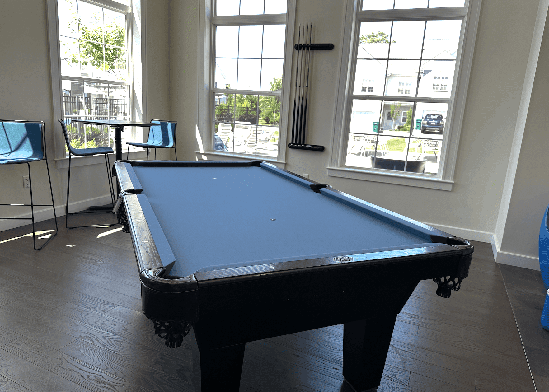 Black Diamond table with light blue cloth in a sunlit clubhouse