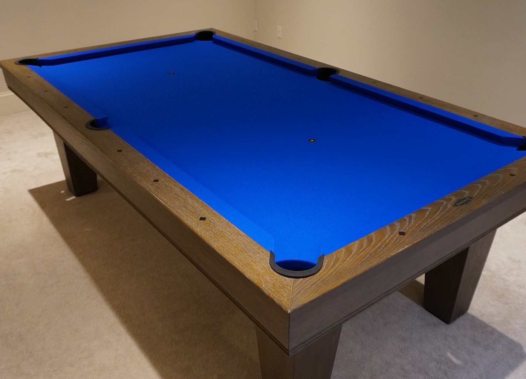 Weathered-oak pool table with royal blue cloth freshly recovered