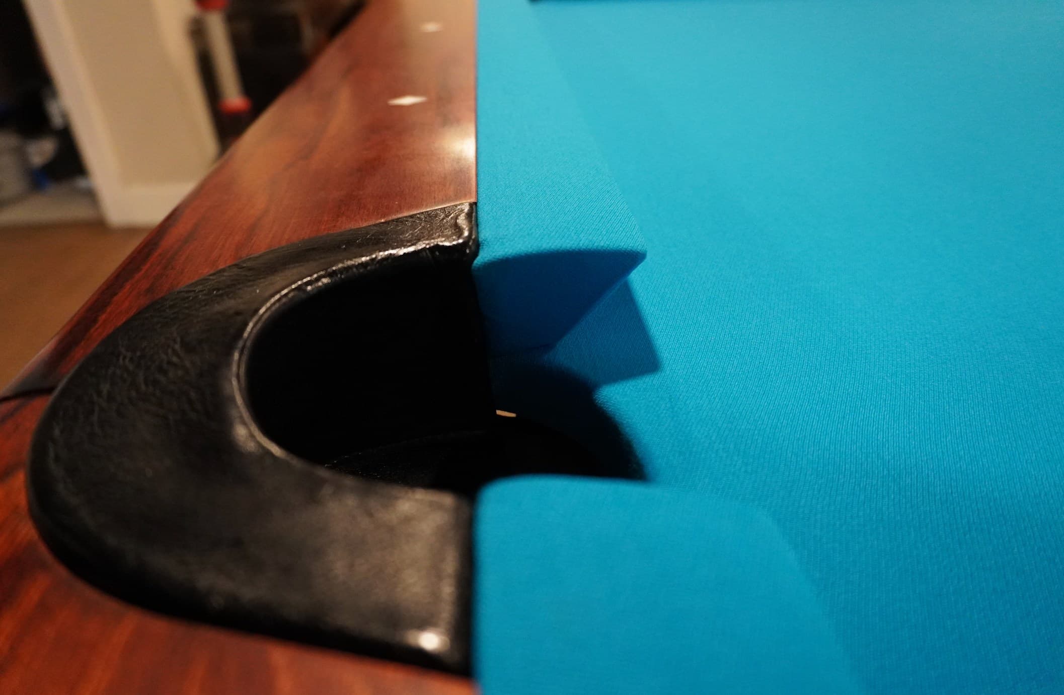 Close-up of a black leather drop pocket with new teal cloth