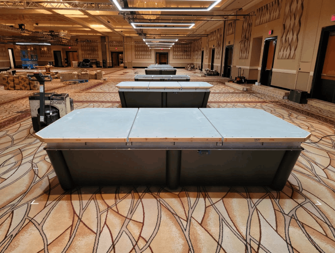 Ballroom full of tournament tables being assembled