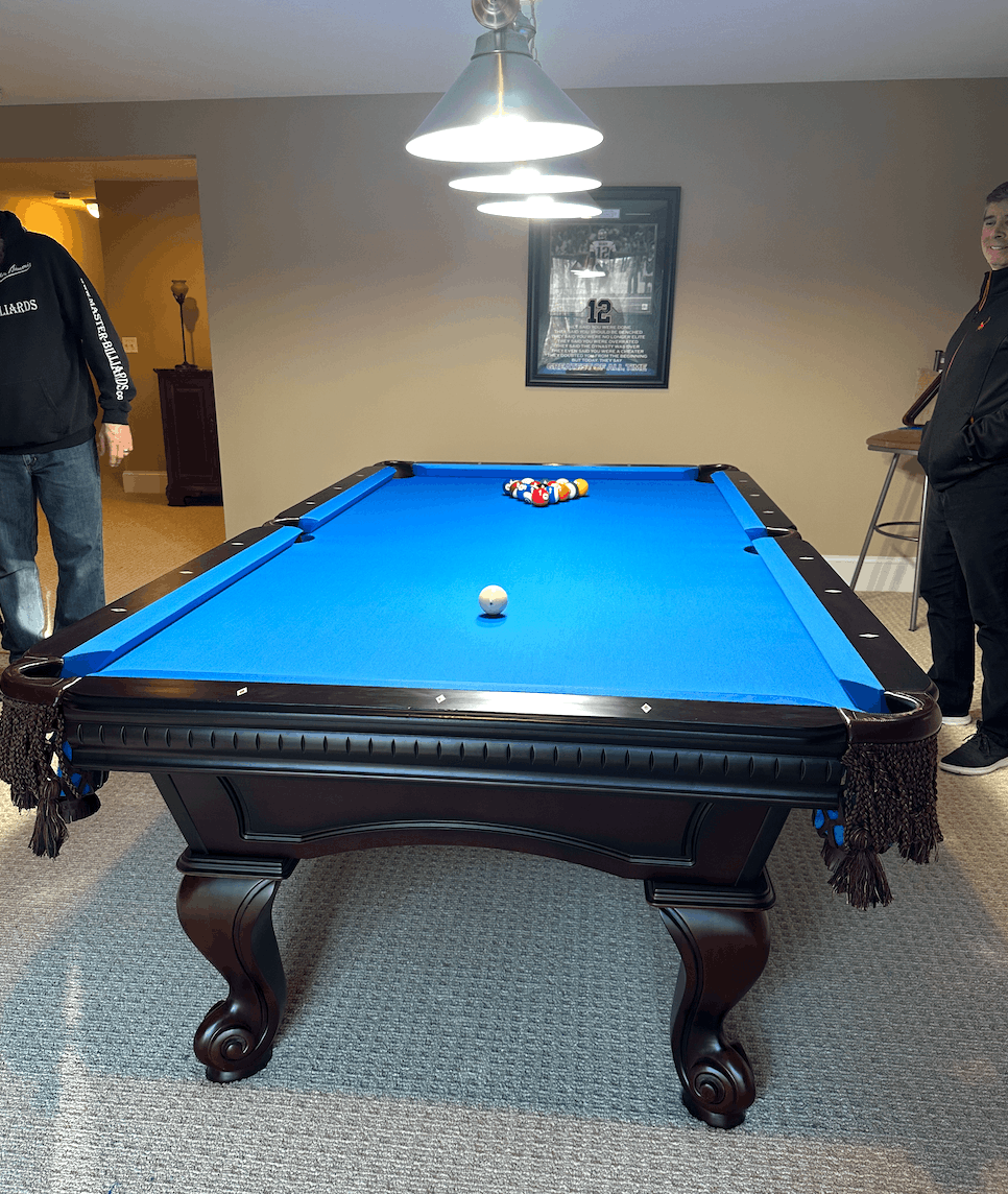 Dark wood table with blue cloth racked and ready to play
