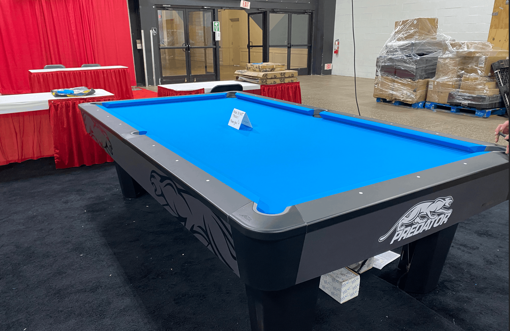 Predator branded tournament table with blue cloth at an expo
