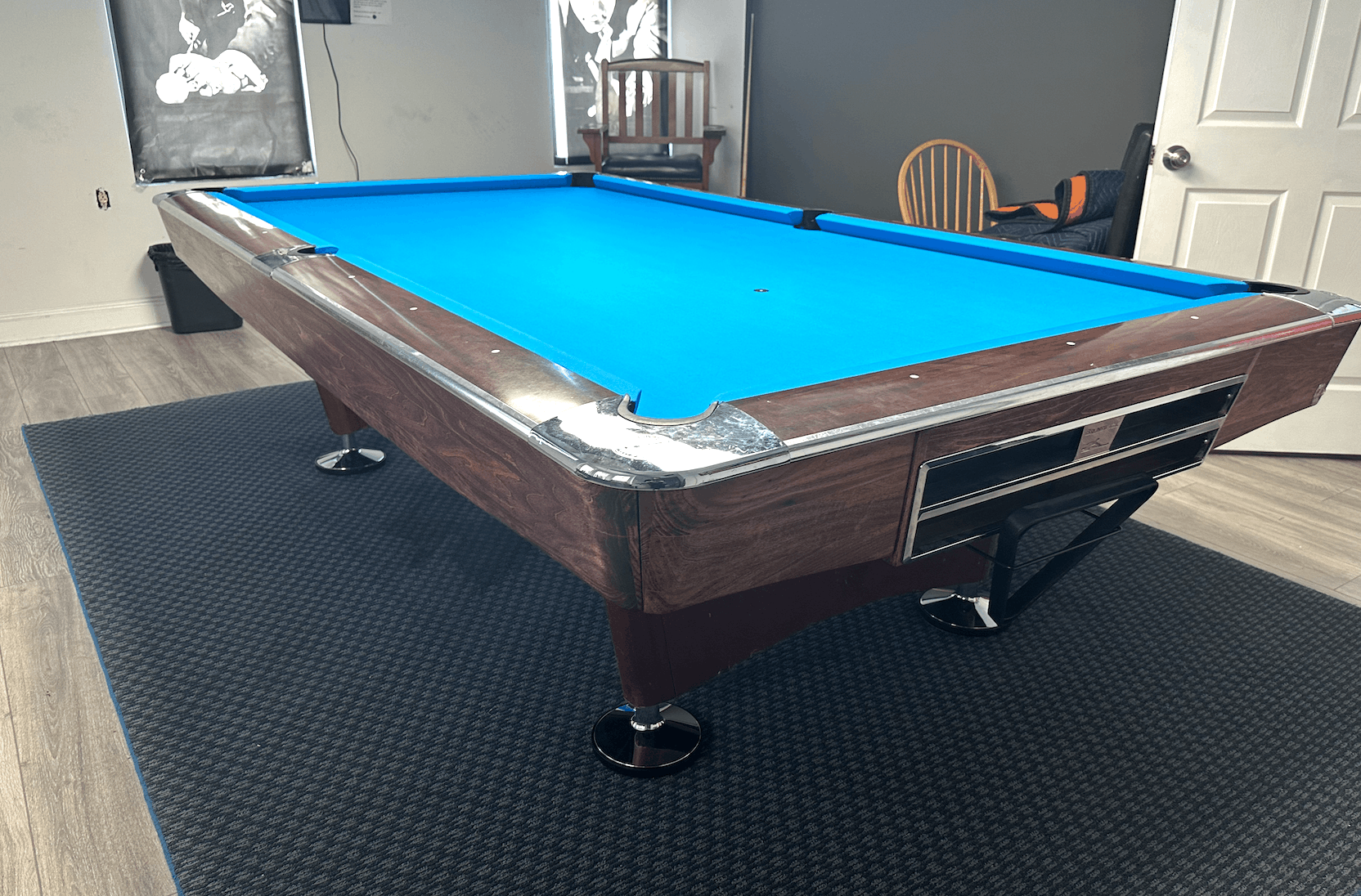 Brown table with blue cloth on a dark area rug