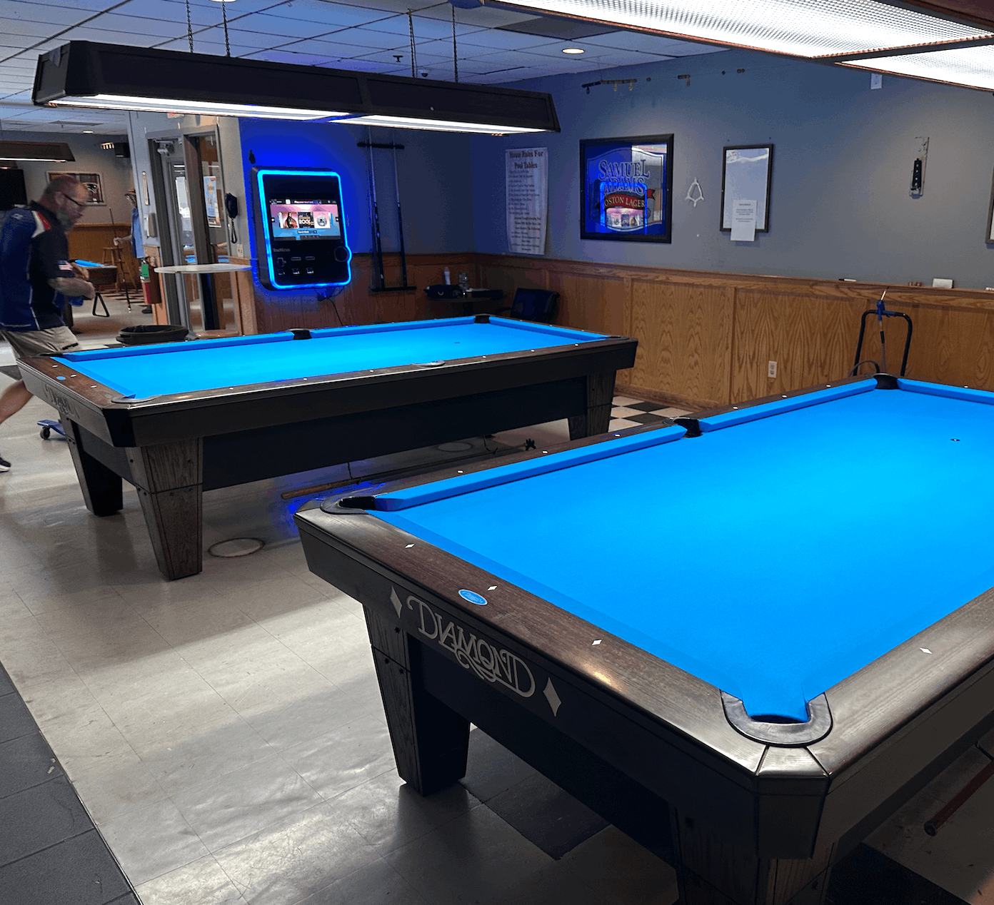 Two Diamond tables with blue cloth in a sports bar