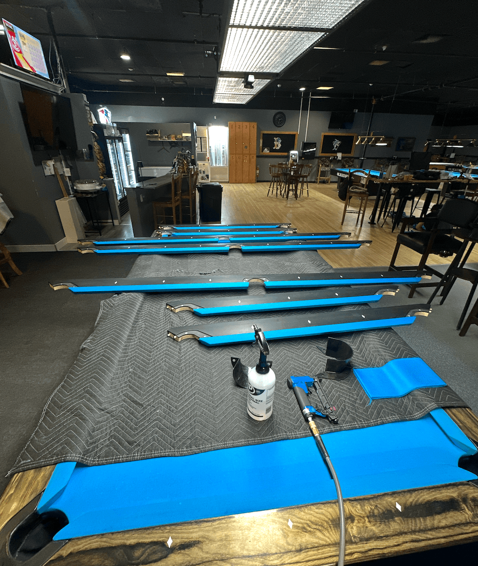 Recovered rails laid out with blue cloth during a table install