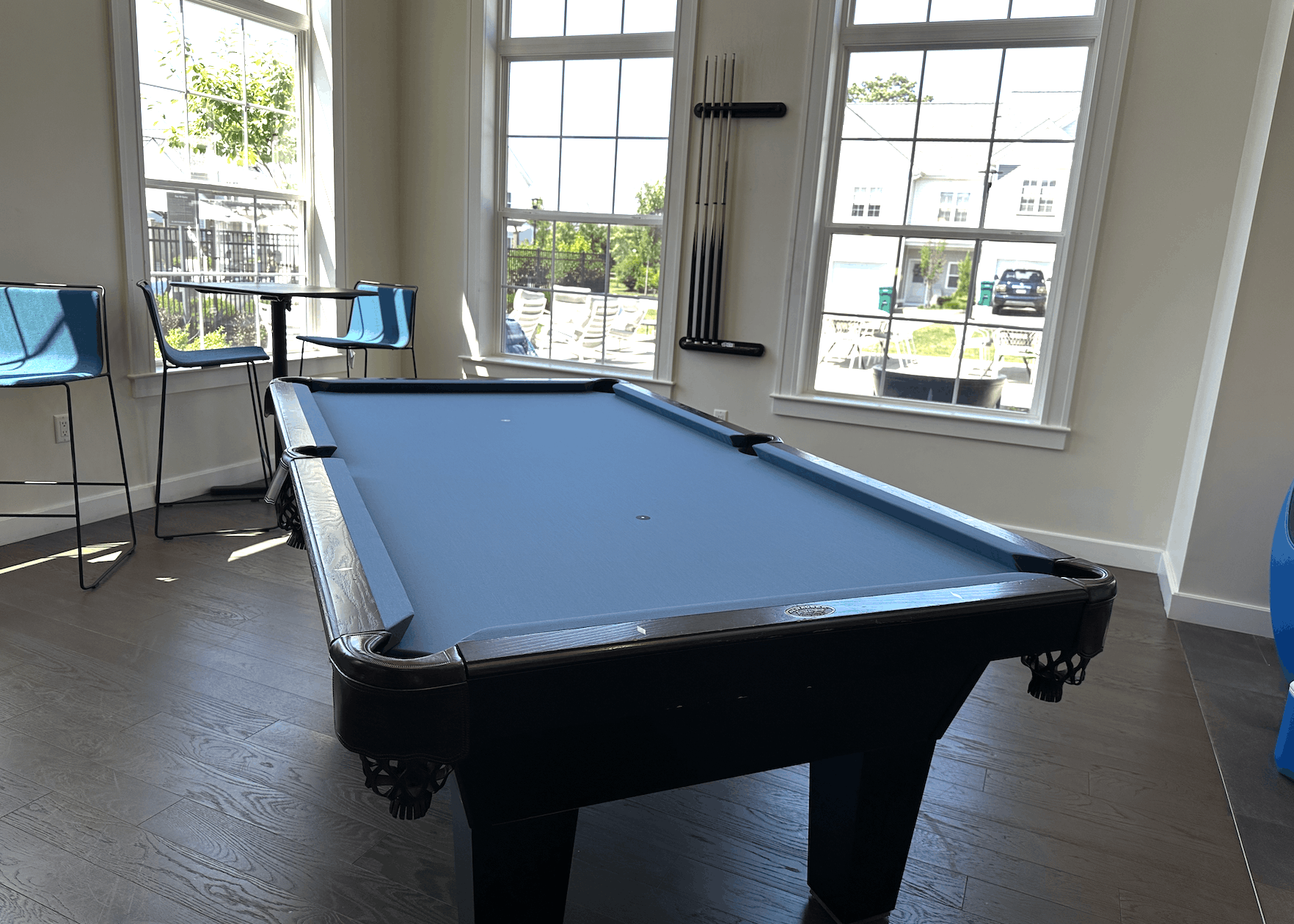 Black Diamond table with light blue cloth in a sunlit clubhouse