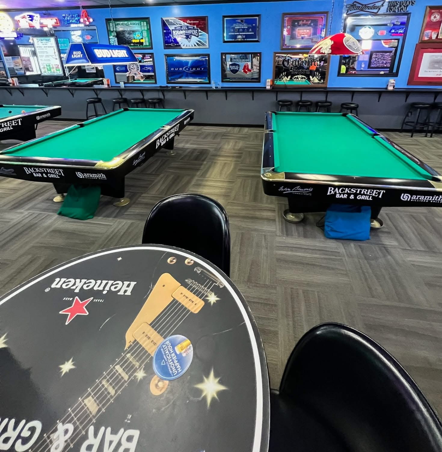 Backstreet Bar & Grill tables with custom brand decals