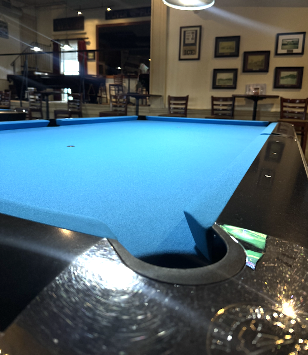 Row of Brunswick Gold Crown tables in Tournament Blue at The Billiards Café