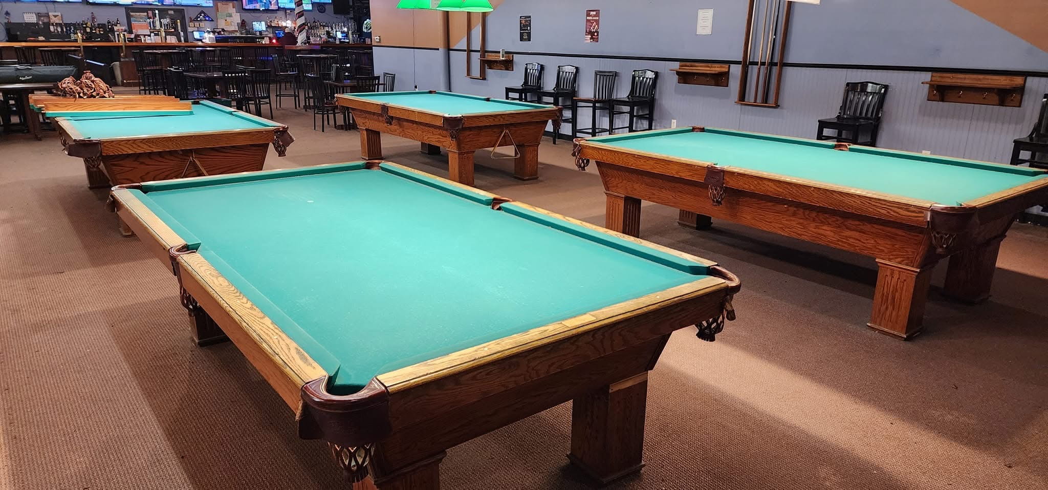 Freshly recovered Olhausen tables near the bar at Break-Away Billiards