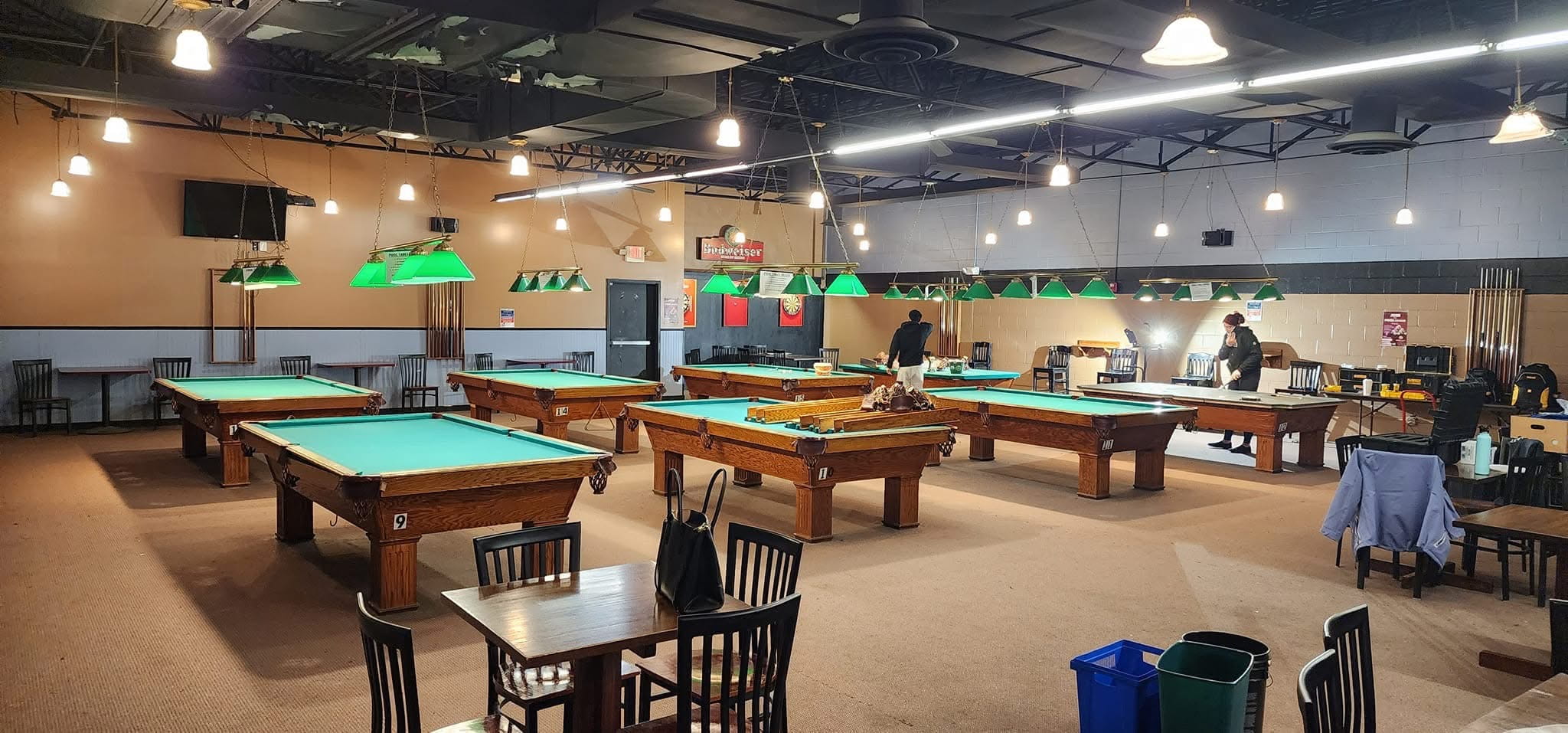 Room full of recovered Olhausen tables at Break-Away Billiards