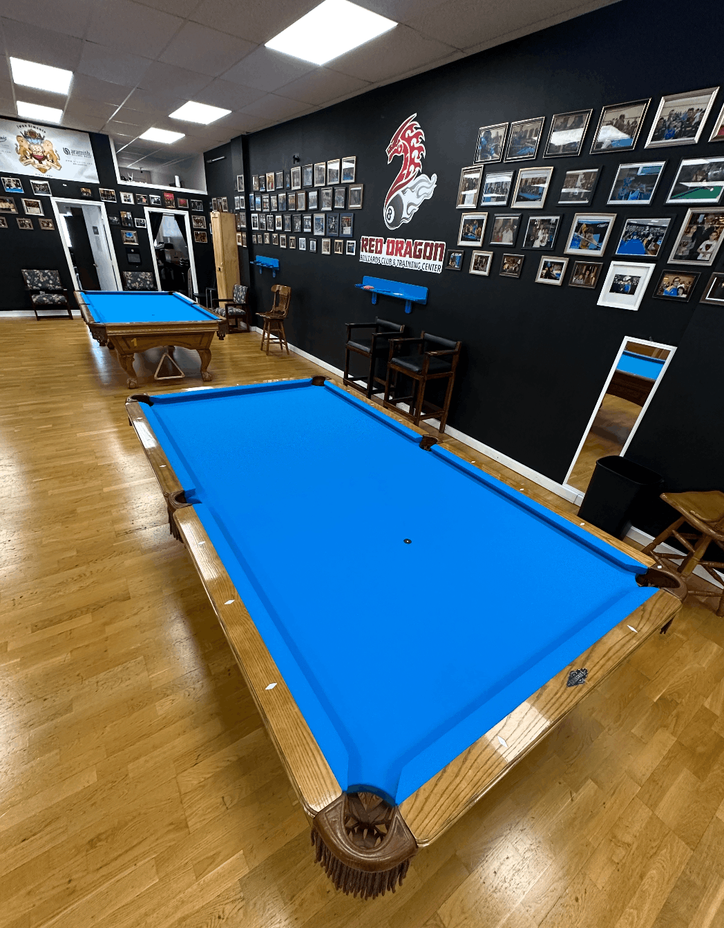 Freshly recovered Brunswick tables beneath the Red Dragon logo wall